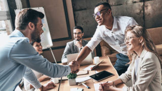 Team Shaking Hands Displaying Company Culture